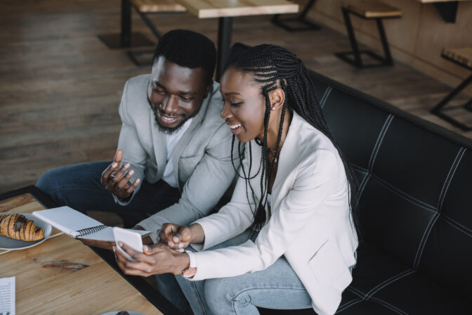 stock-photo-smiling-african-american-businesspeople-discussing-work-business-meeting-cafe